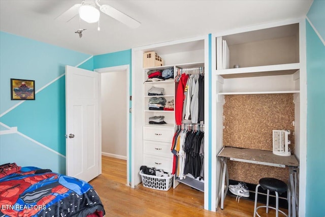 bedroom featuring a ceiling fan, wood finished floors, and a closet