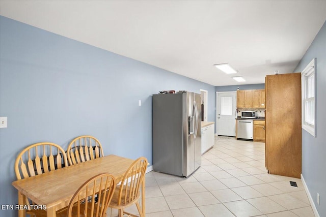 kitchen featuring light tile patterned floors and stainless steel appliances