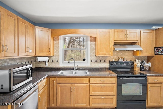 kitchen with under cabinet range hood, backsplash, appliances with stainless steel finishes, and a sink