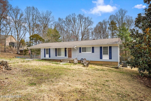 ranch-style house with cooling unit and a front yard