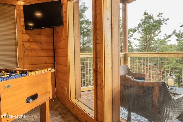 doorway to outside featuring wooden walls