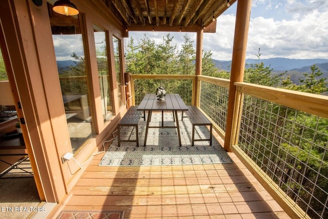 unfurnished sunroom featuring a wealth of natural light and a mountain view