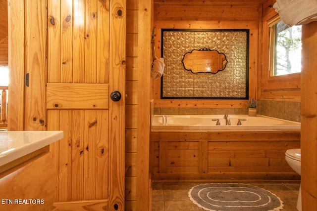 full bathroom with a bath, tile patterned flooring, and toilet