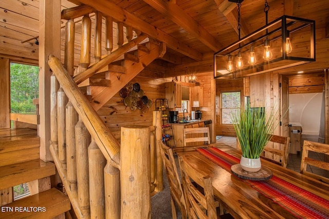 interior space with wooden ceiling, stairs, wooden walls, and beamed ceiling