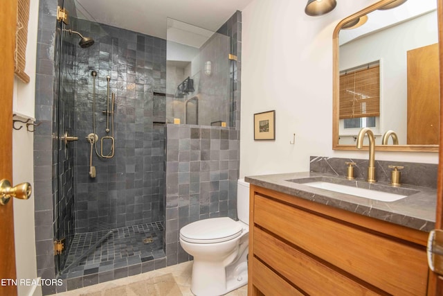 bathroom with vanity, toilet, and a stall shower