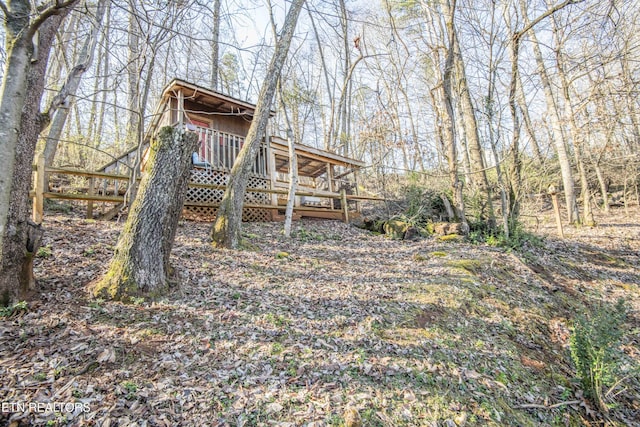 exterior space with a wooden deck and stairs