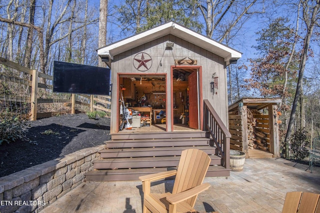 entrance to property featuring a patio area and fence