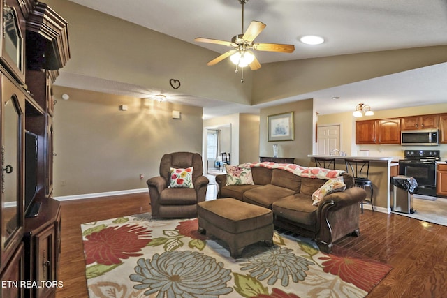 living room with high vaulted ceiling, a ceiling fan, dark wood-type flooring, and baseboards