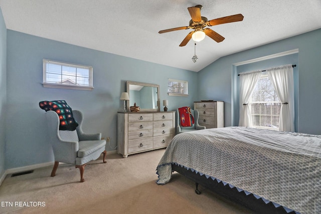 carpeted bedroom with visible vents, ceiling fan, baseboards, lofted ceiling, and a textured ceiling