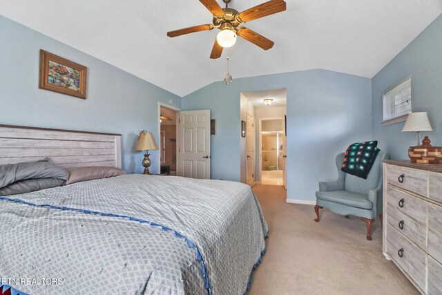 bedroom featuring light carpet, ensuite bathroom, a ceiling fan, baseboards, and vaulted ceiling