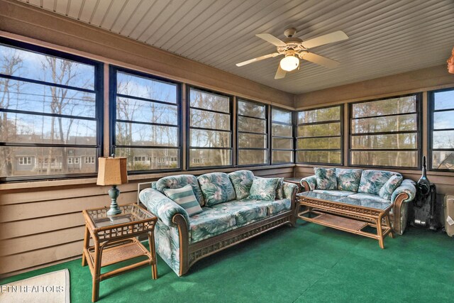 sunroom featuring ceiling fan