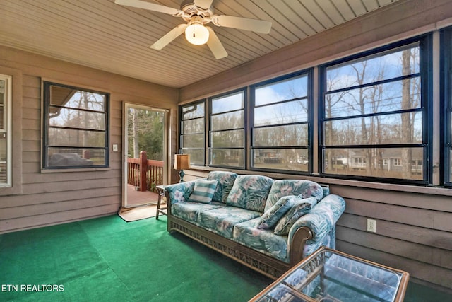 sunroom / solarium featuring wood ceiling and ceiling fan