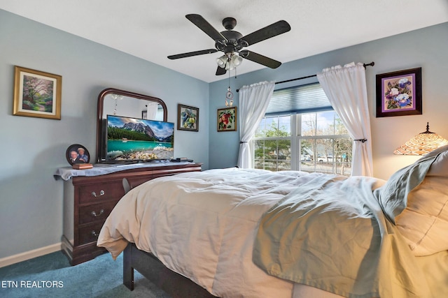 carpeted bedroom with ceiling fan and baseboards