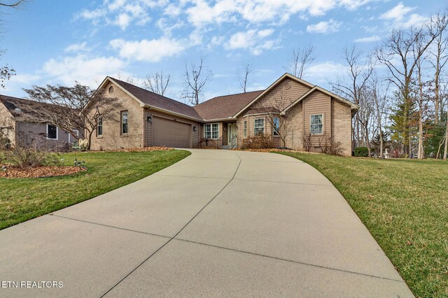 ranch-style home featuring a front yard, brick siding, and an attached garage