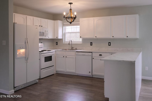 kitchen with a peninsula, white appliances, dark wood-type flooring, and a sink