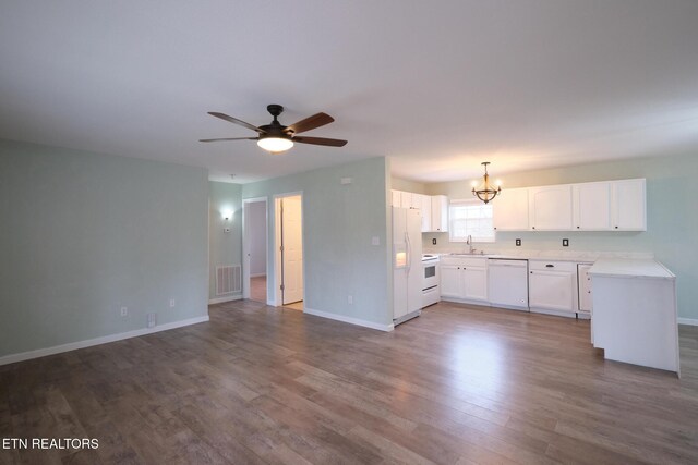 kitchen with white appliances, visible vents, white cabinetry, open floor plan, and dark wood-style floors