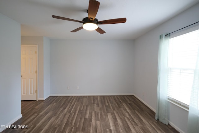 empty room featuring baseboards and wood finished floors