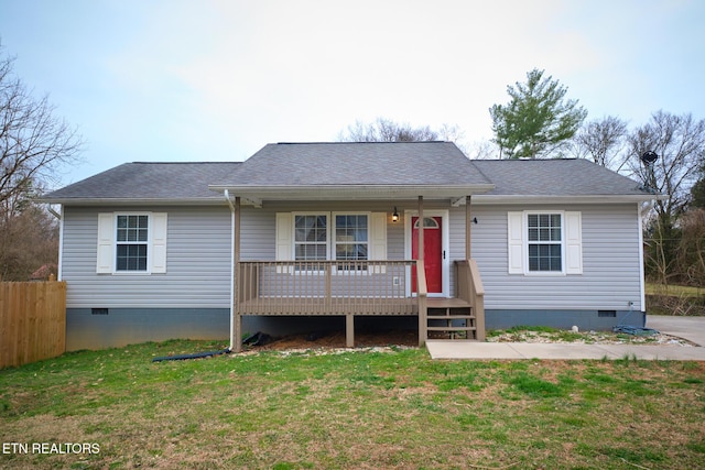 ranch-style house with crawl space, roof with shingles, and a front yard