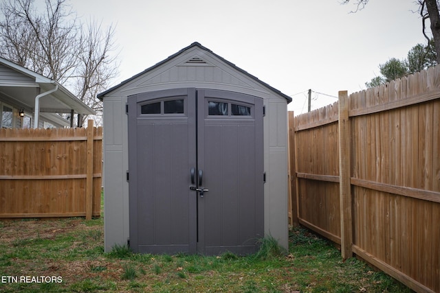 view of shed with fence