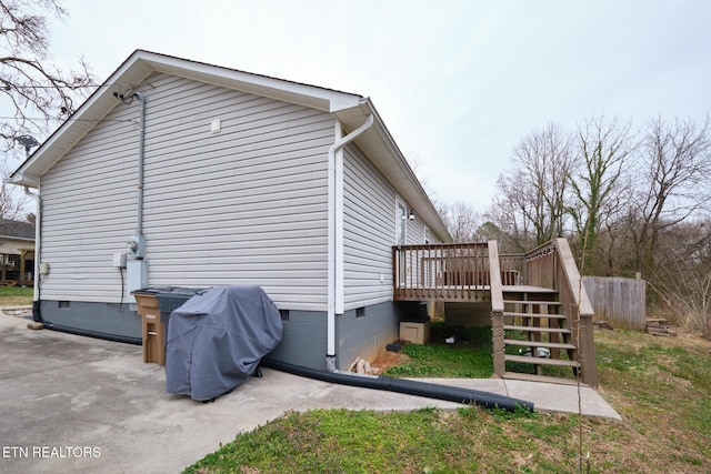 view of property exterior featuring a deck, stairway, and crawl space