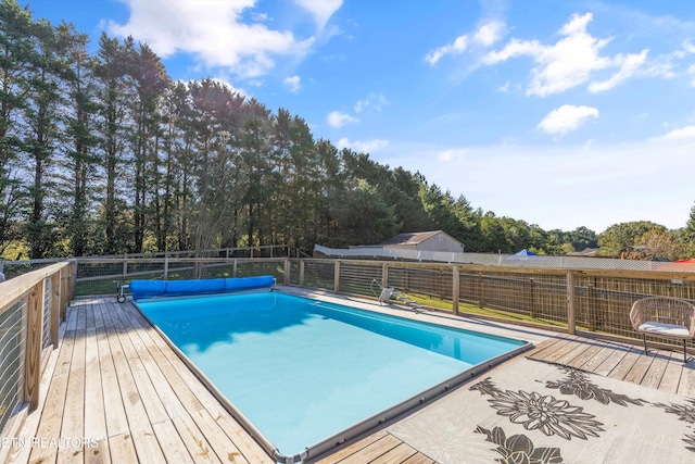 view of pool featuring a fenced in pool and a deck