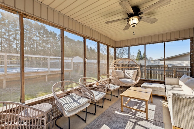 sunroom with a ceiling fan