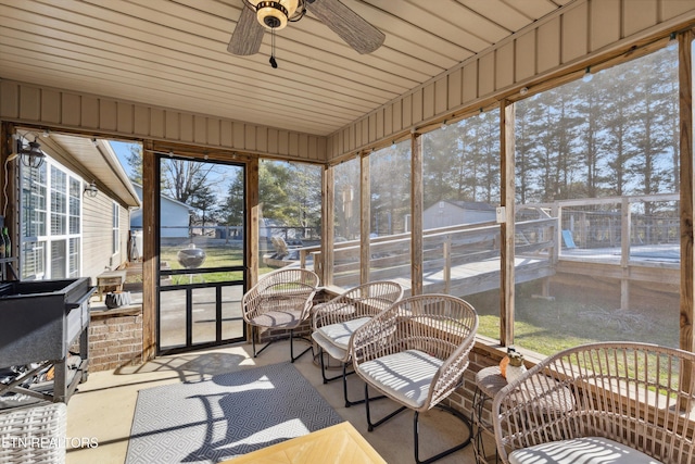 unfurnished sunroom with a ceiling fan