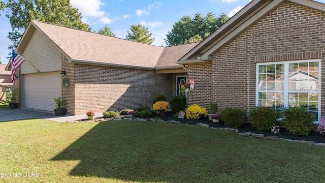 ranch-style house with brick siding, a front yard, roof with shingles, driveway, and an attached garage