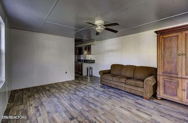 unfurnished living room with wood finished floors and a ceiling fan