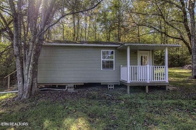 view of outdoor structure with covered porch