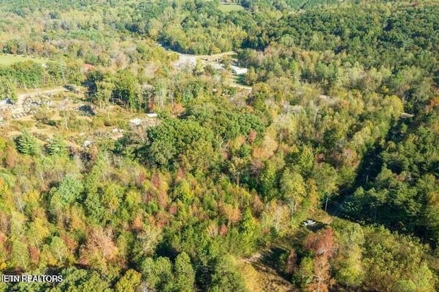 drone / aerial view featuring a view of trees