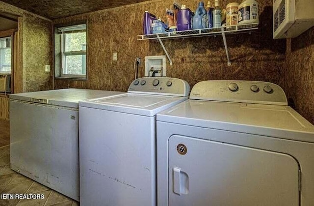 laundry room featuring light tile patterned floors, laundry area, and washer and clothes dryer