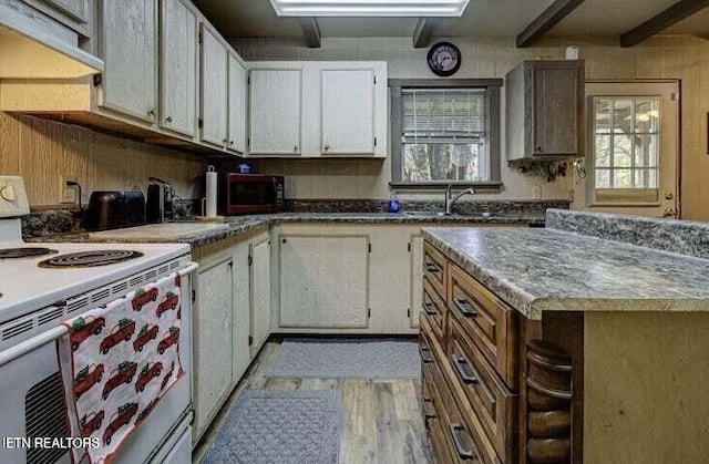 kitchen featuring a sink, under cabinet range hood, white electric stove, and a wealth of natural light