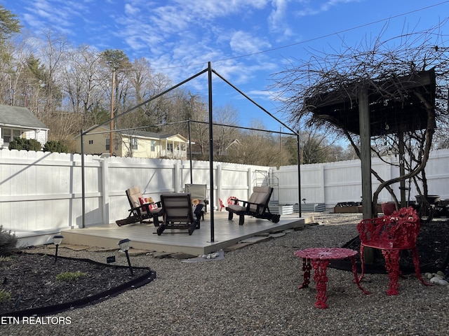 view of yard with a deck and a fenced backyard