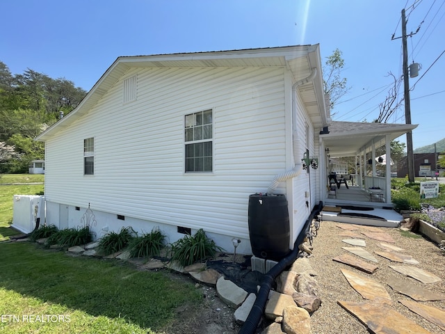 view of home's exterior with covered porch and crawl space