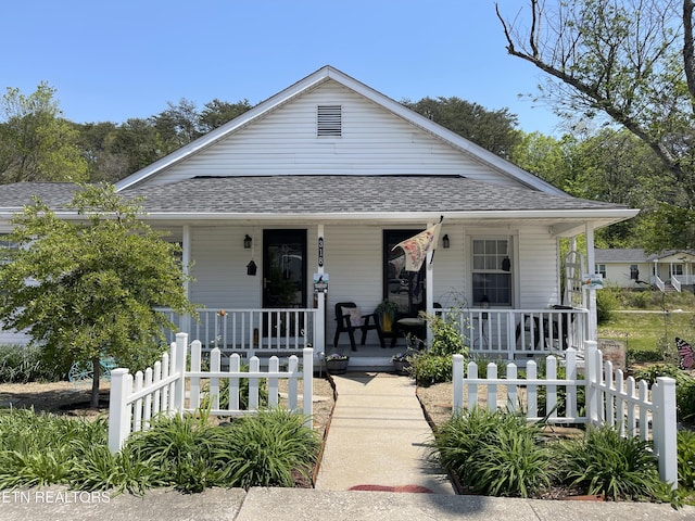 bungalow-style house with fence, a porch, and a shingled roof