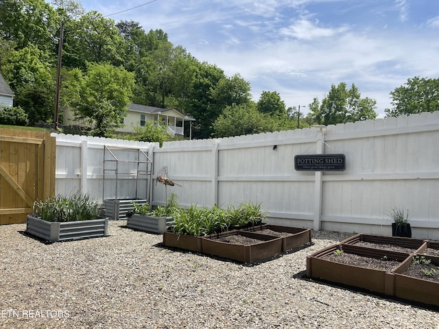 view of patio / terrace featuring fence and a garden