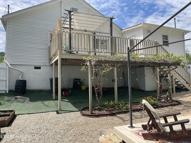 back of house with a deck, a patio area, and stairs