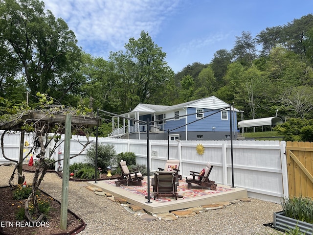 exterior space featuring an outdoor fire pit and a fenced backyard