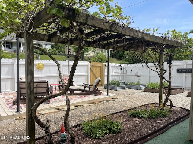 view of patio featuring a pergola, a vegetable garden, and a fenced backyard