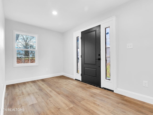 entryway with recessed lighting, light wood-style flooring, and baseboards