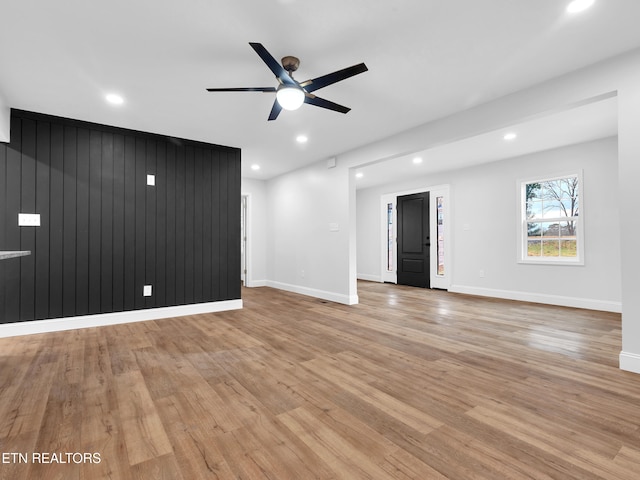 unfurnished living room with light wood-type flooring, ceiling fan, baseboards, and recessed lighting