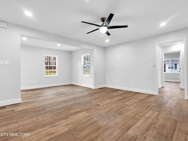 empty room with recessed lighting, baseboards, ceiling fan, and light wood finished floors