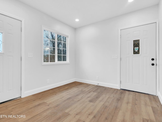 foyer entrance featuring light wood-style floors, baseboards, and recessed lighting