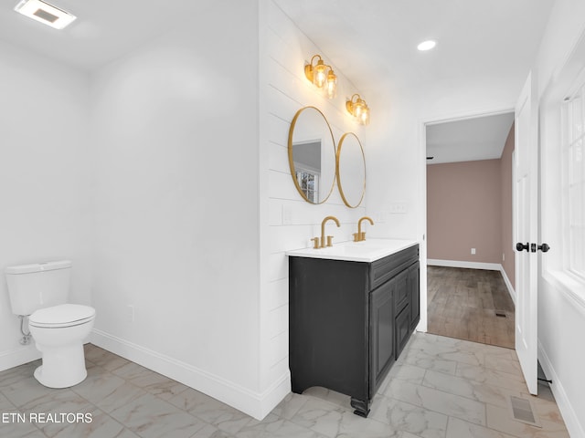 bathroom with recessed lighting, marble finish floor, vanity, and baseboards