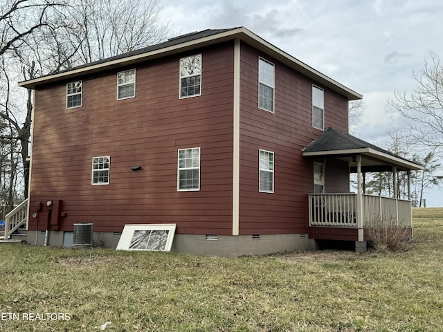 rear view of house featuring a porch, crawl space, a lawn, and central air condition unit