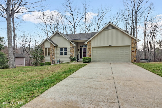 view of front of home with stone siding, driveway, an attached garage, and a front lawn