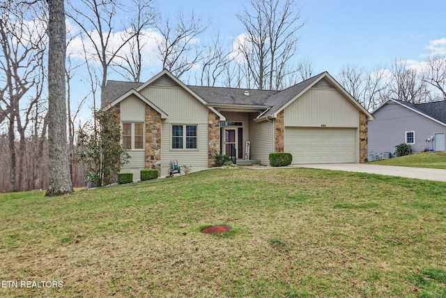 ranch-style home with driveway, a front yard, a garage, and a shingled roof