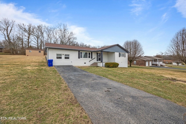 single story home with aphalt driveway, a front lawn, and brick siding