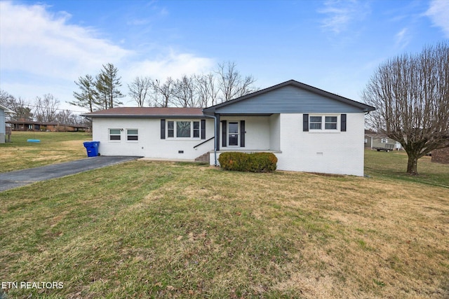 ranch-style home featuring driveway, brick siding, crawl space, and a front yard